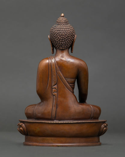 Shakyamuni Buddha statue with oxidized copper finish, intricate robe details, and traditional Nepalese Buddhist craftsmanship.