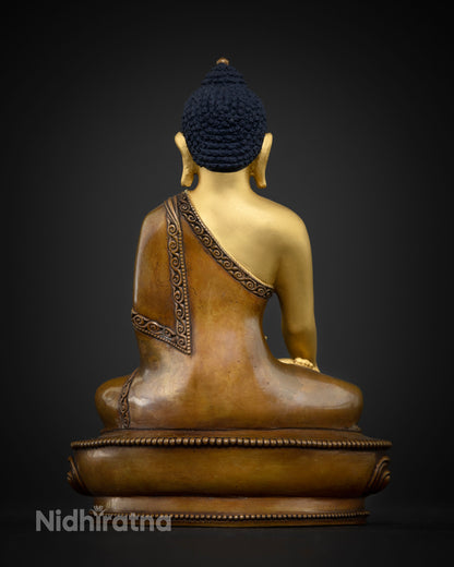 Shakyamuni Buddha statue with oxidized copper finish.