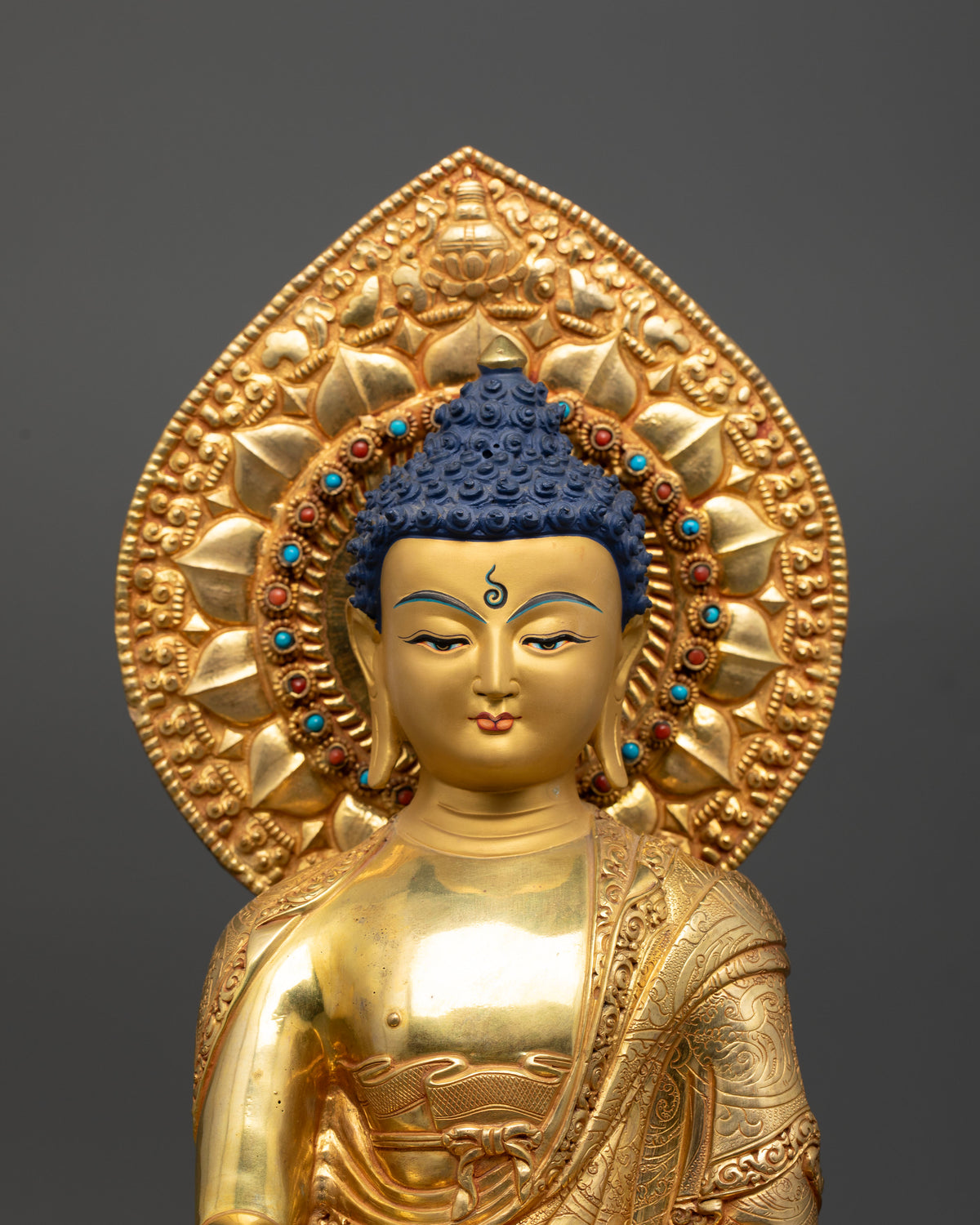 Shakyamuni Buddha Statue with serene gold-painted face and jeweled halo