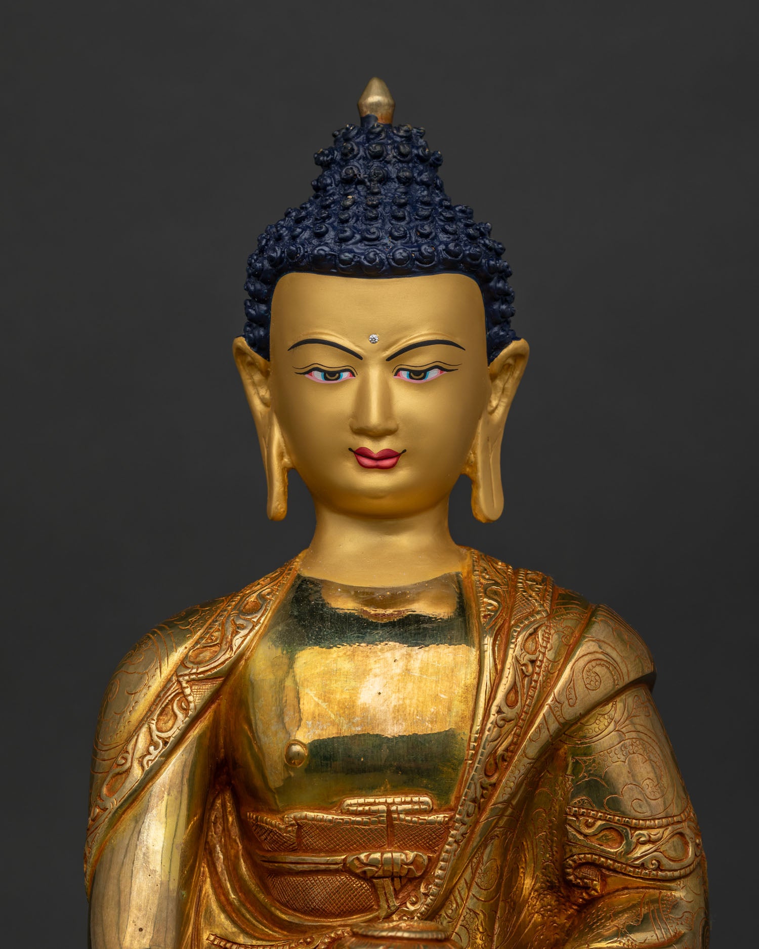 Shakyamuni Buddha with serene gold painted face and floral carvings