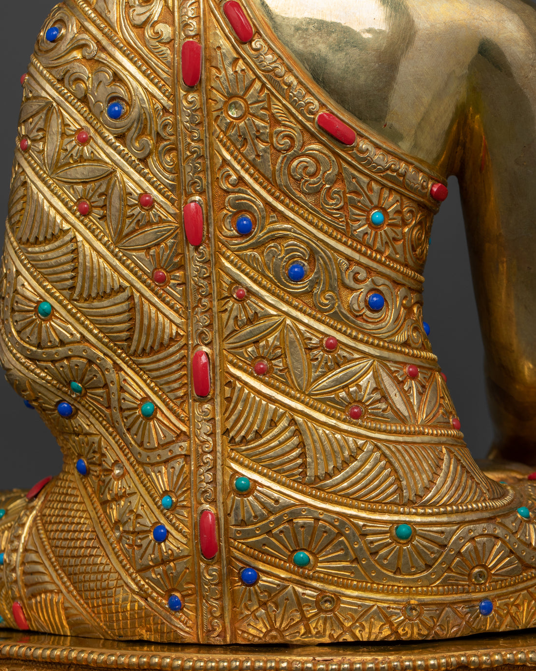 the back view of shakyamuni buddha statue with robe adorned with gemstones