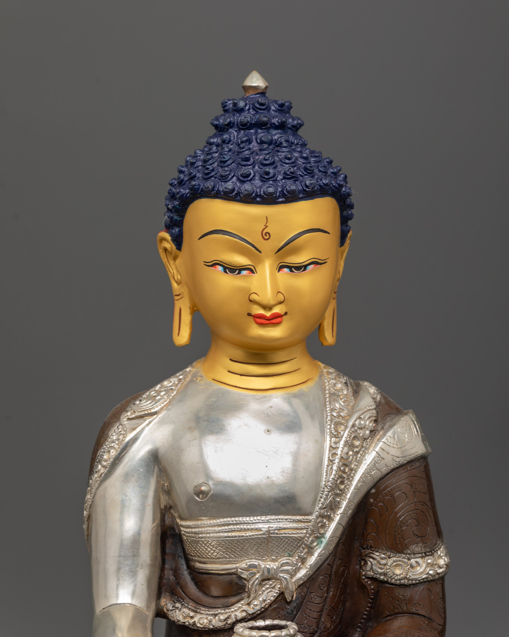shakyamuni buddha statue close up gold gilded face silver plated monk bowl fine details
