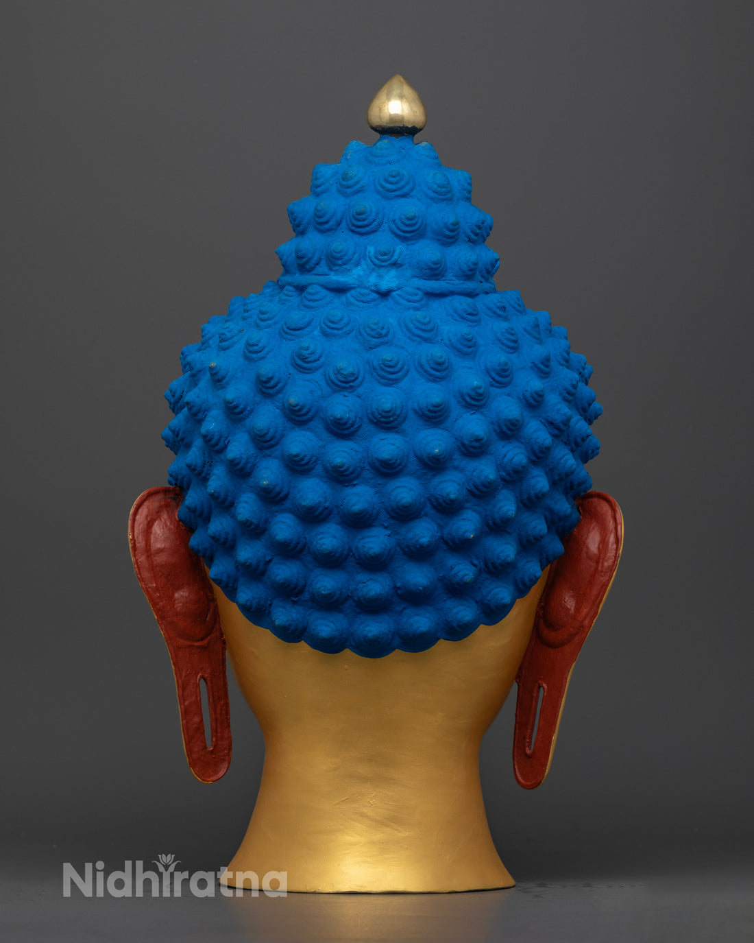 shakyamuni face buddha statue back view of blue colored curly hair and elongated ears