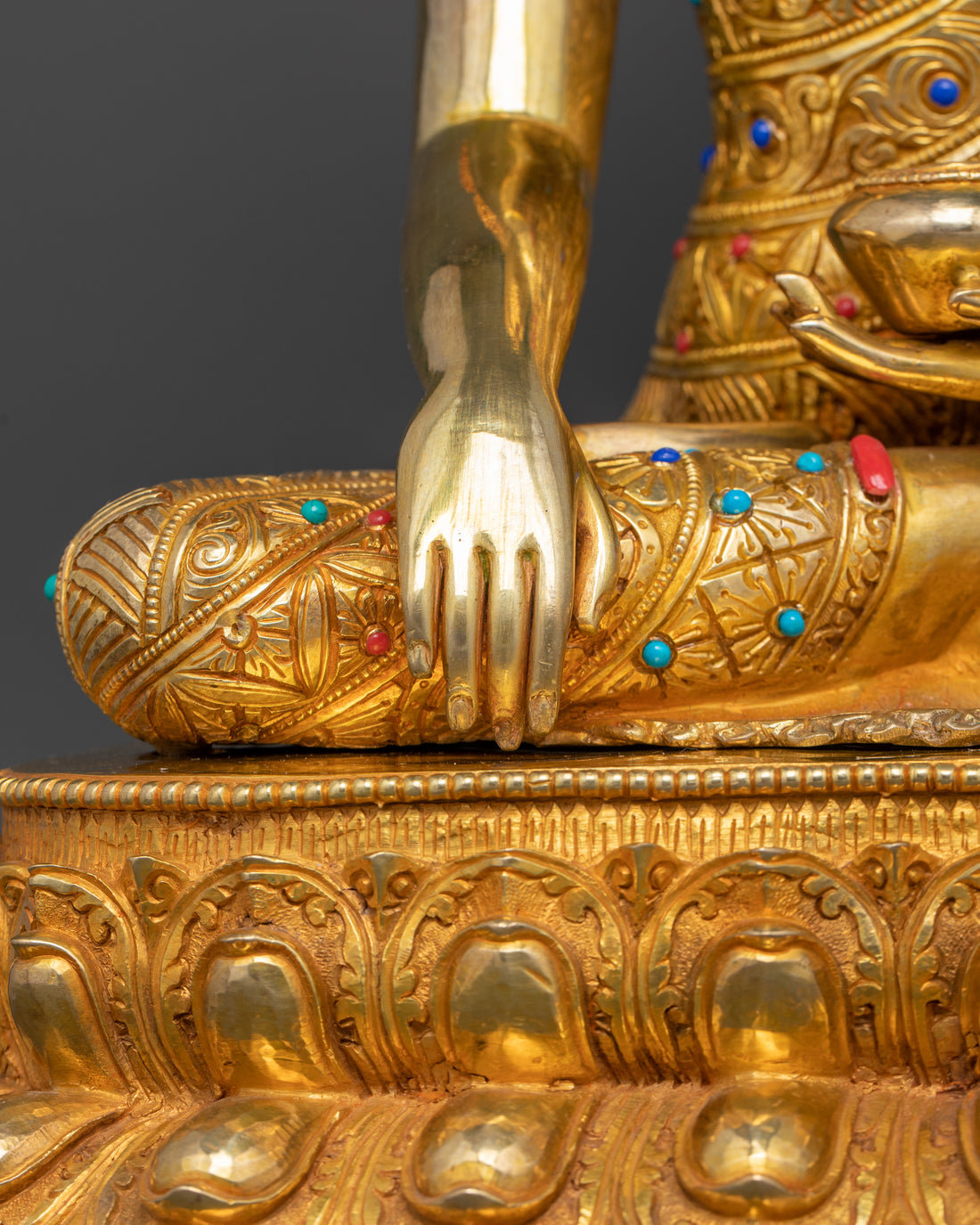 the hand of gold plated shakyamuni buddha statue touching the earth to represent enlightment