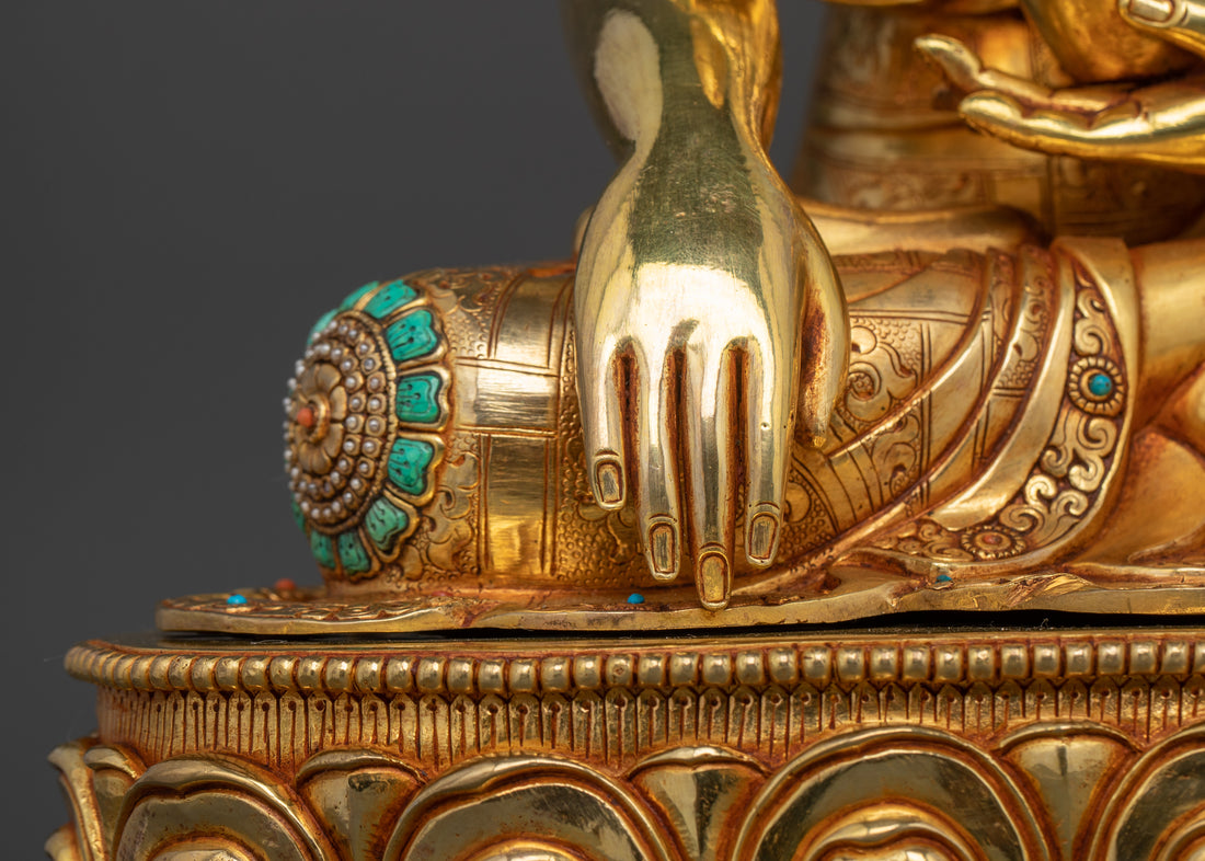 the right hand of gold coated shakyamuni budhha statue