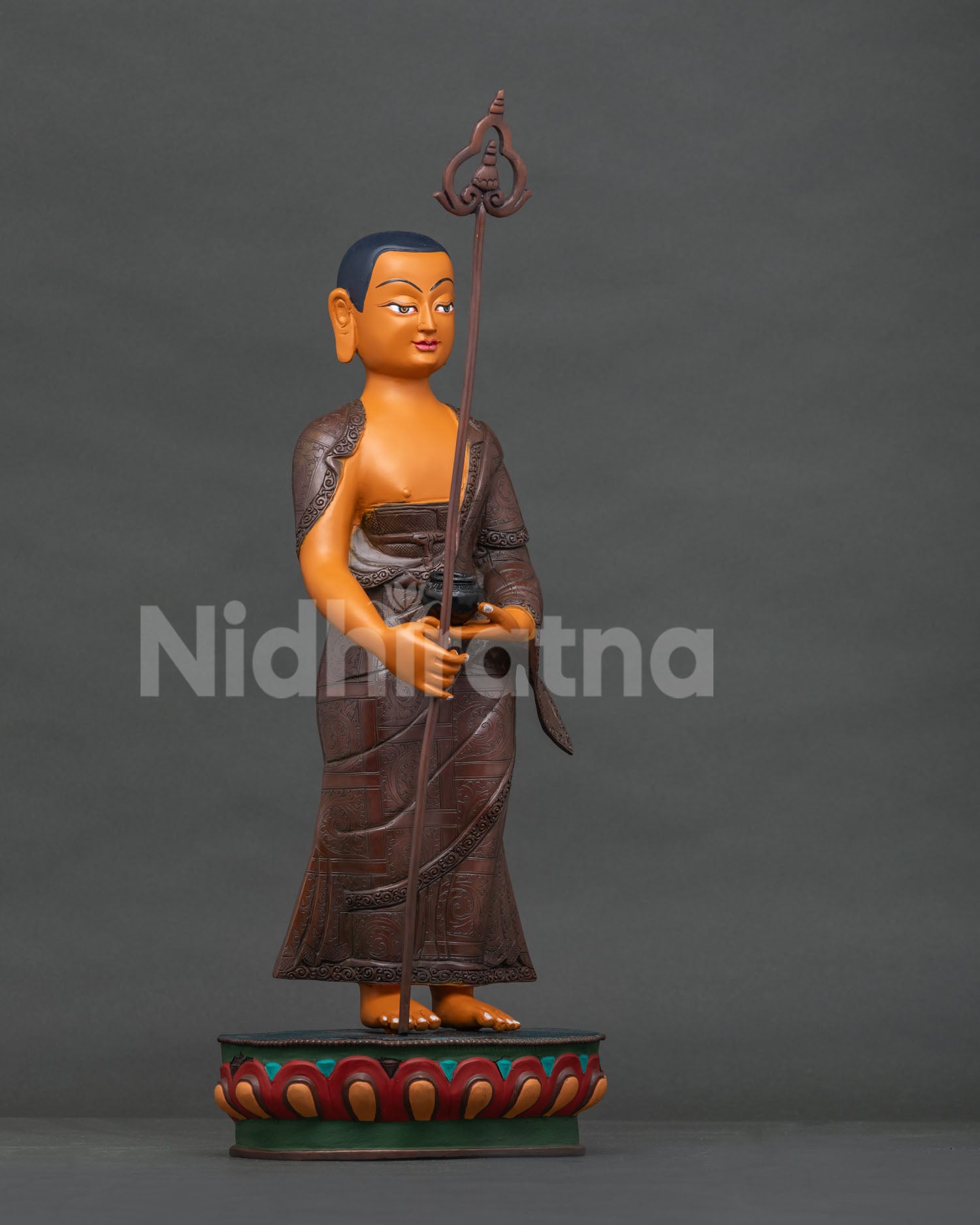 Shariputra copper statue right side view, alms bowl and staff detail