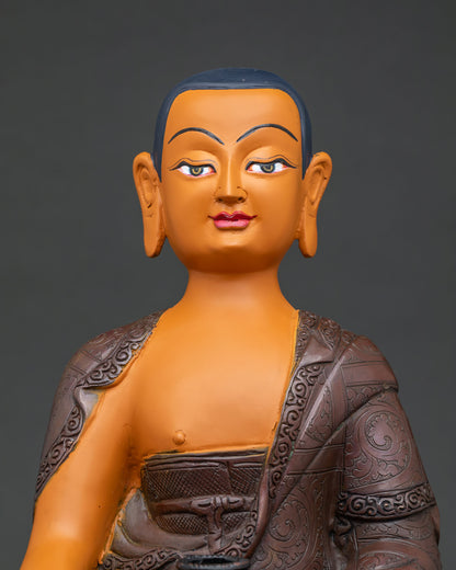 Shariputra statue close up, engraved copper monastic robe detail