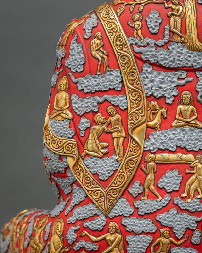 Shoulder detail of Shakyamuni Buddha statue robe with gold relief life scenes and scrollwork border