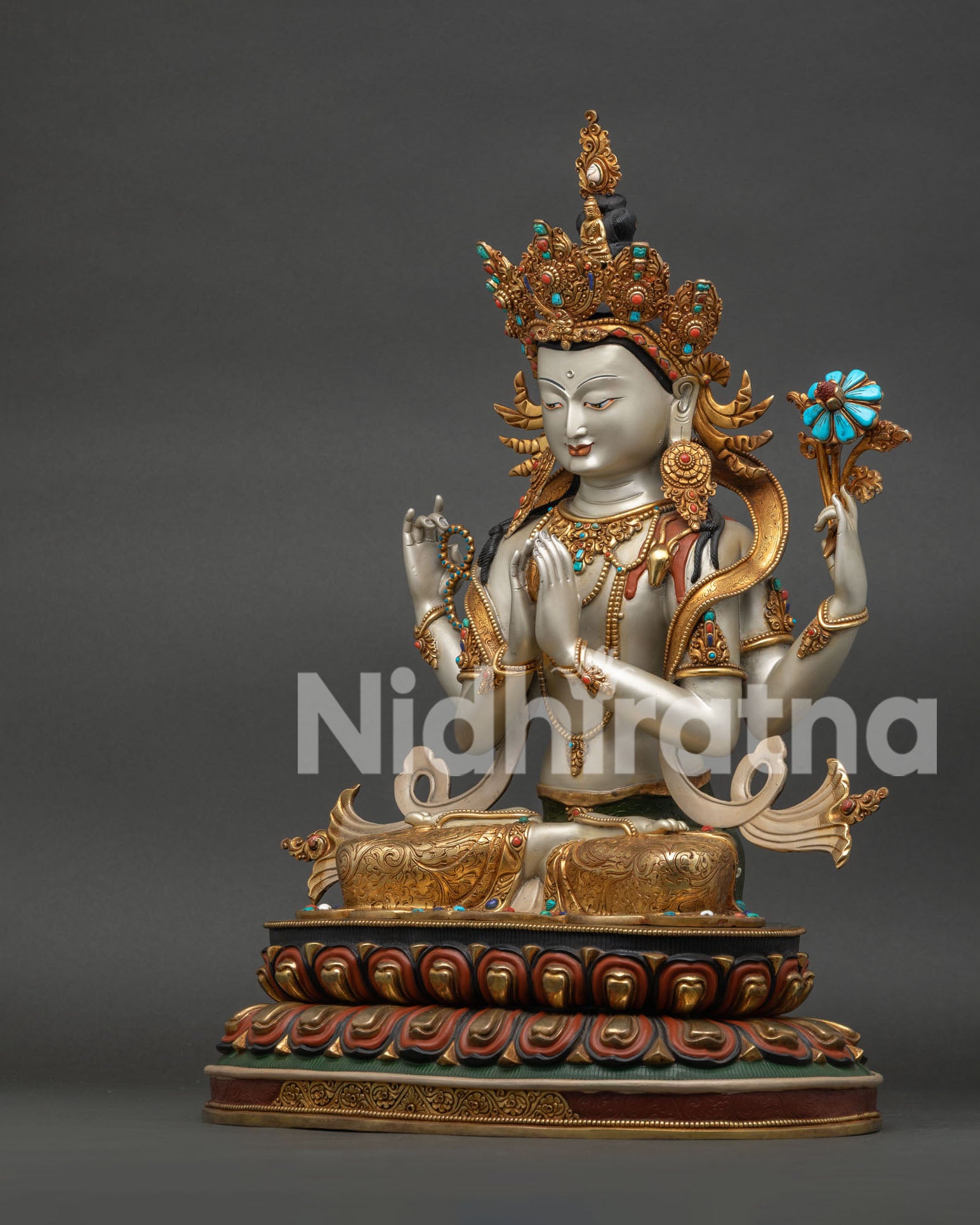 Side angle of Four-Armed Chenrezig statue showing crown, robe drape, and hand mudras