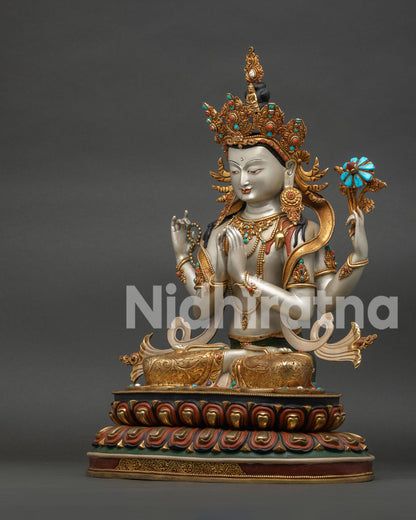Side angle of Four-Armed Chenrezig statue showing crown, robe drape, and hand mudras