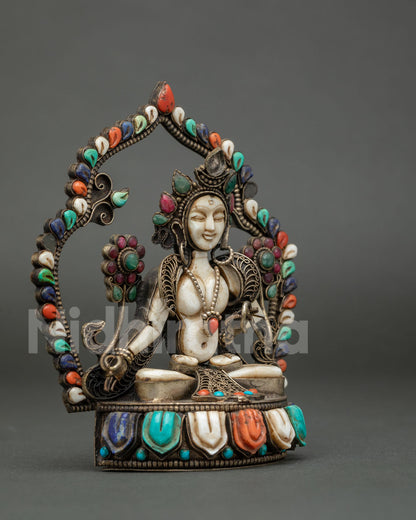 Side angle of Goddess White Tara figurine with filigree detailing and lotus pedestal