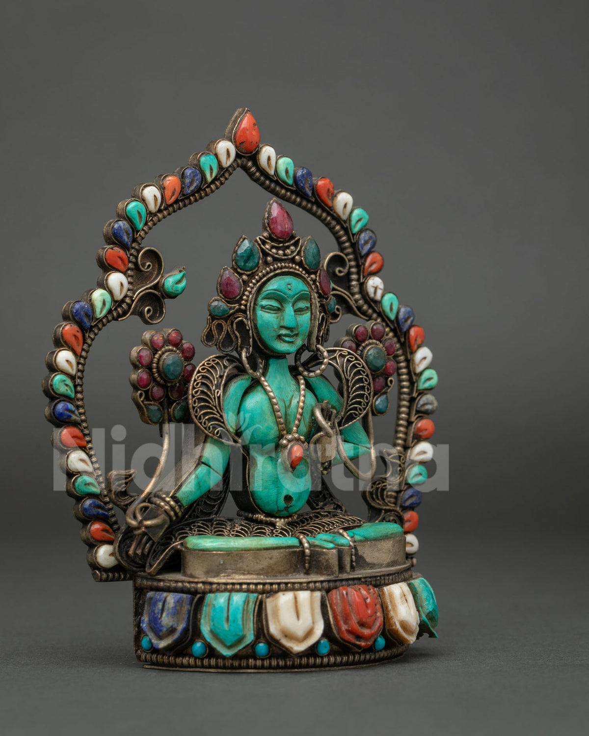 Side angle of Green Tara turquoise figurine with filigree detailing and lotus pedestal