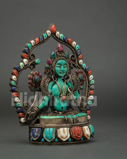 Side angle of Green Tara turquoise figurine with filigree detailing and lotus pedestal