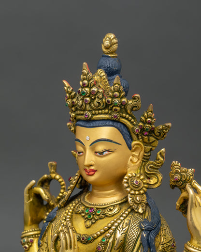 side close-up of chenrezig statue, four arms holding lotus, rosary, and chintamani