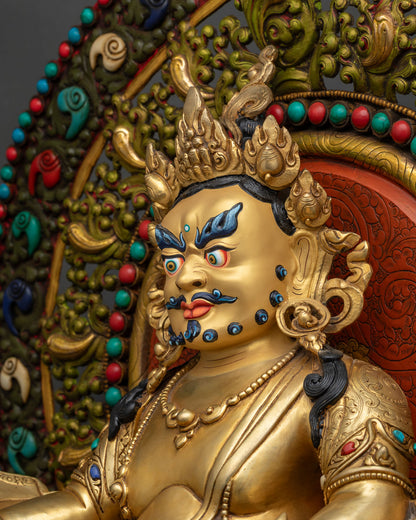Side close-up detail of gold gilded Dzambhala throne statue, handmade in Nepal