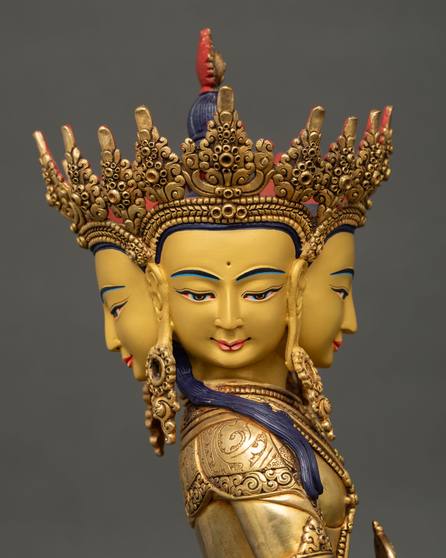 Side close up face of vairocana buddha with calm expression, ornate headdress and sacred gold accents