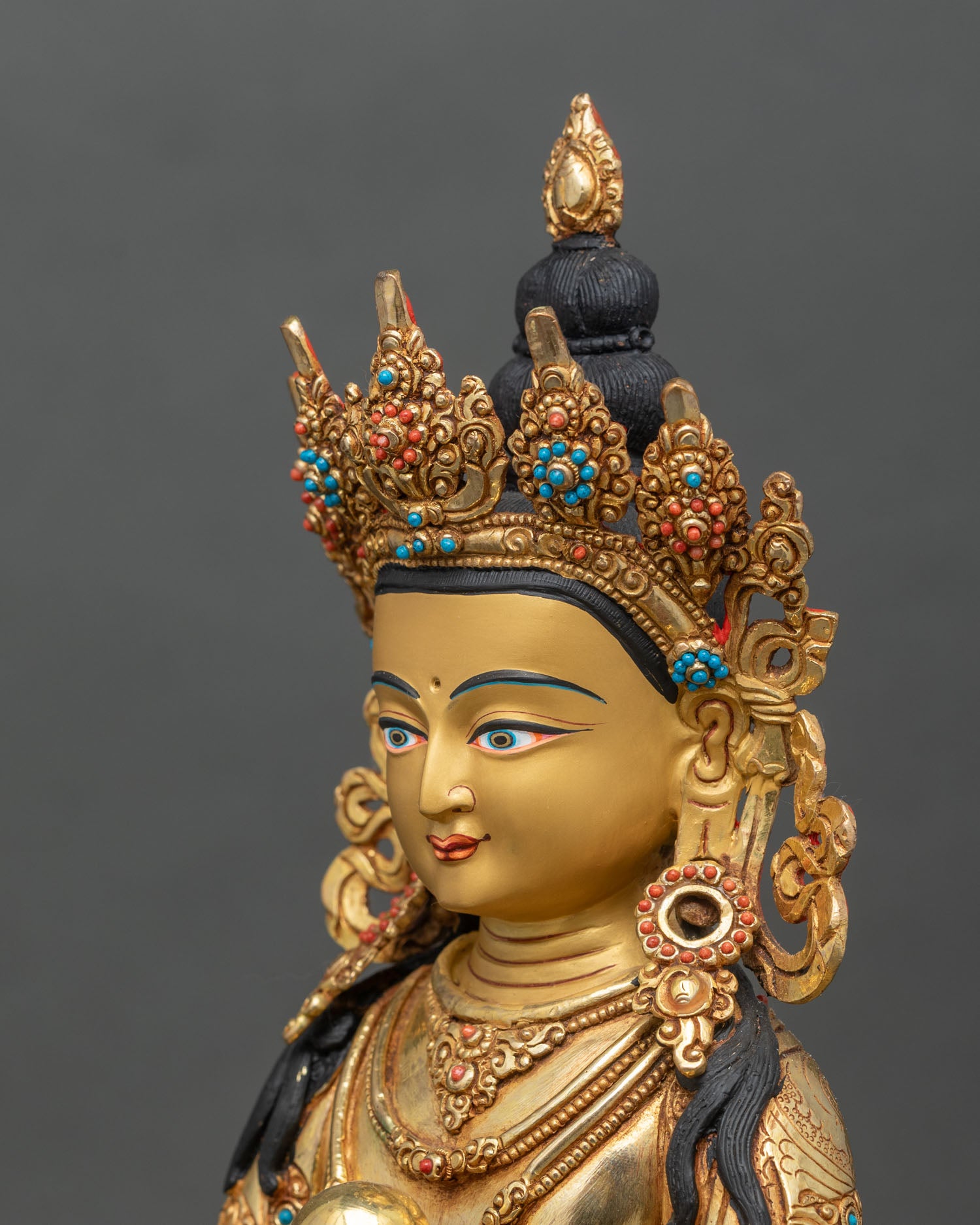 detailed side close-up ksitigarbha statue holding sacred chintamani with floral halo