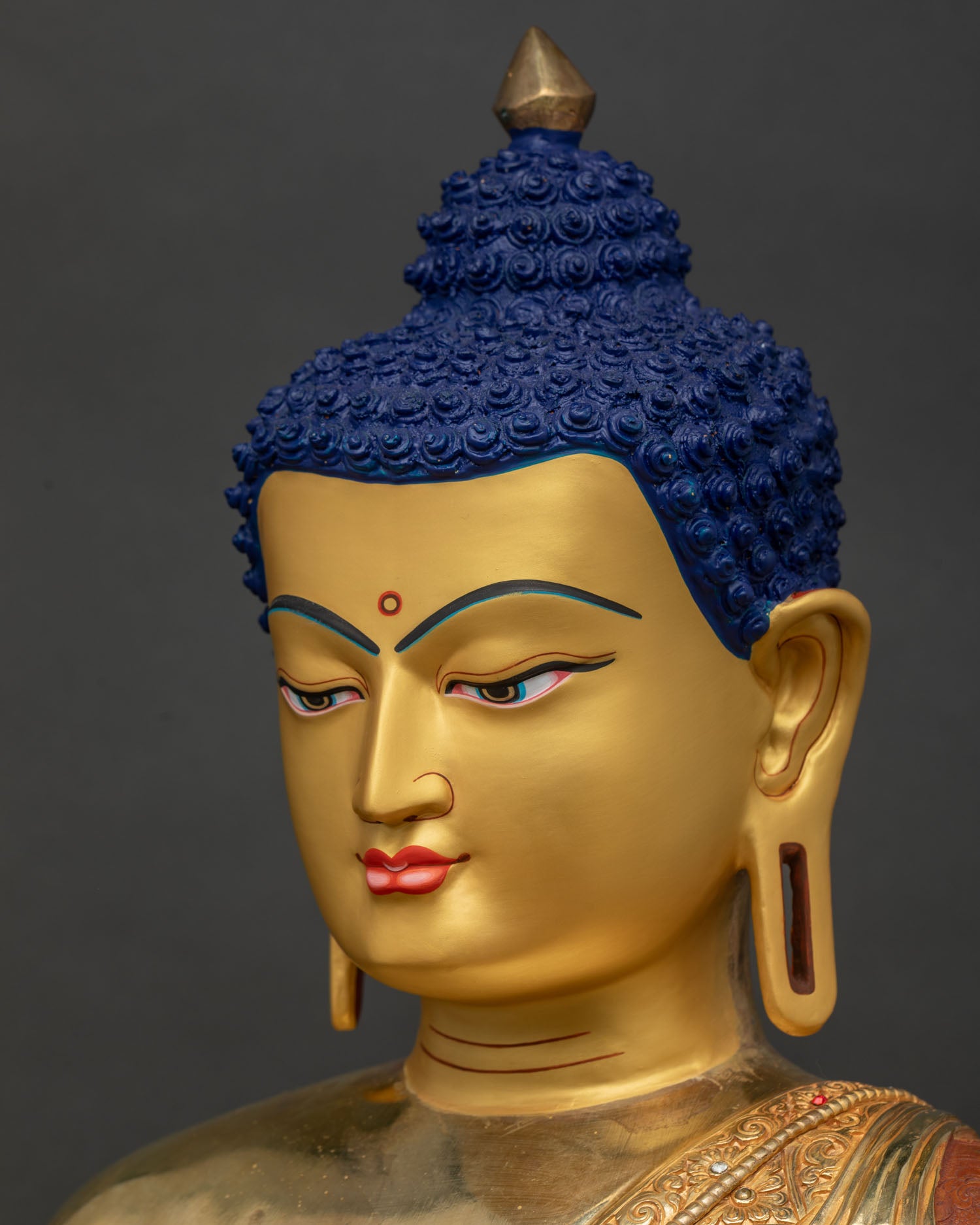 Side close-up of Amitabha Buddha face showing fine gold-gilded detailing