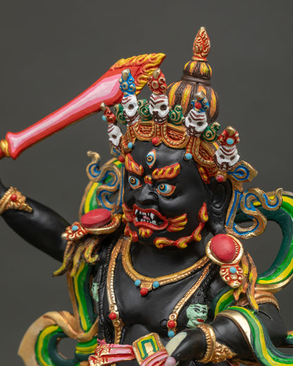 Side close-up of Black Manjushri statue detailing sword, ornaments, and gold fire-gilded halo