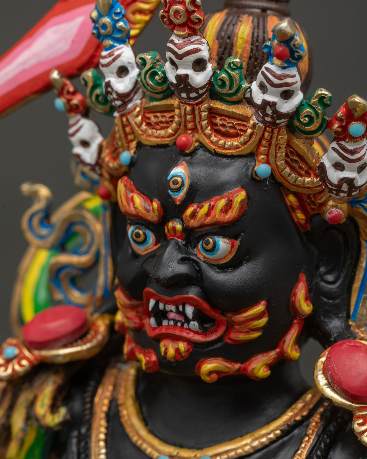 Side close-up of Black Manjushri's face showing wrathful expression and skull crown detail