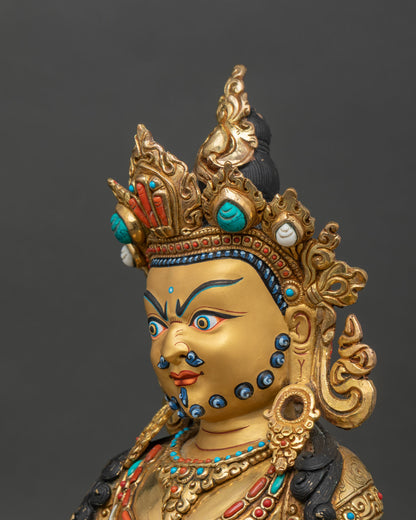 Side close-up of Dzambhala statue highlighting jewelry and sculpted details