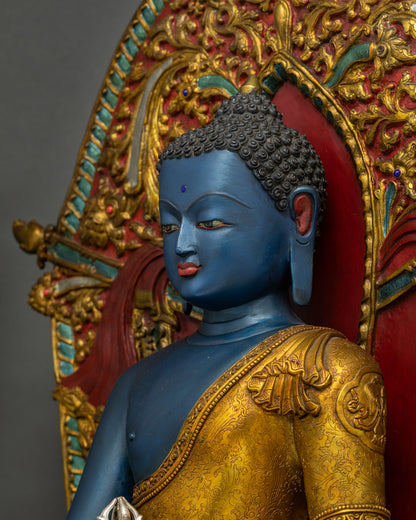 Side close up of gold gilded Akshobhya Buddha statue showing repoussé detail from Nepal
