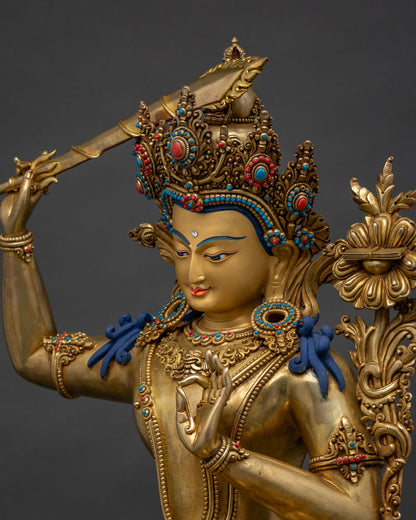Side close-up of gold-gilded Manjushri statue, turquoise coral inlay, Nepal
