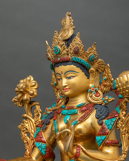 Side close up of Green Tara copper statue showing carved crown, jewelry and stone inlay