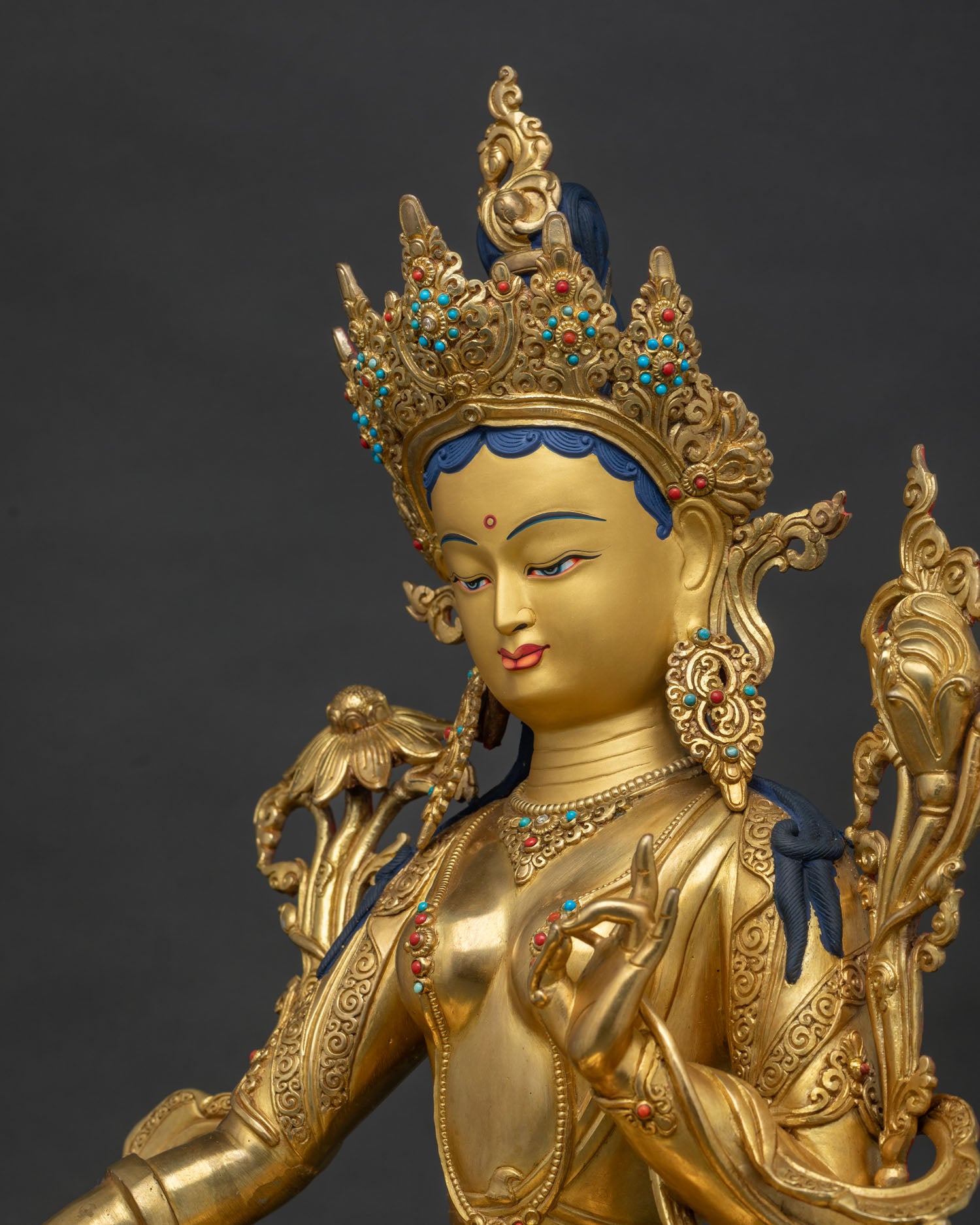 Side close up of Green Tara Statue highlighting Varada Mudra and hand-chased artistry