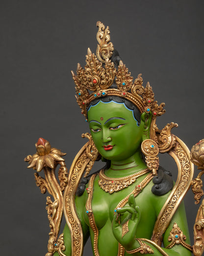 Side close-up of Green Tara statue showing detailed copper carving and 24K gold gilding