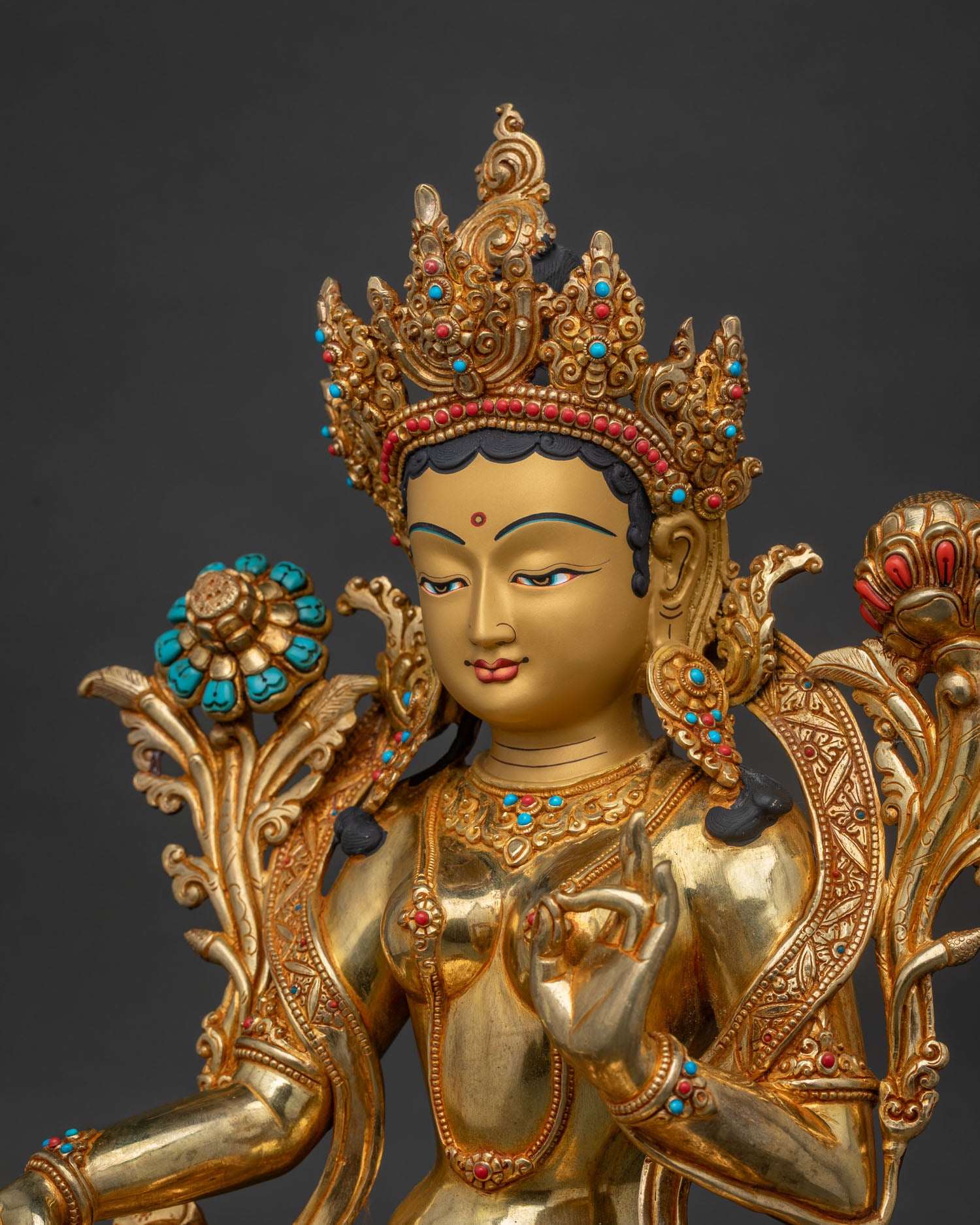 Side close-up of Green Tara statue showing hand-set gemstone details