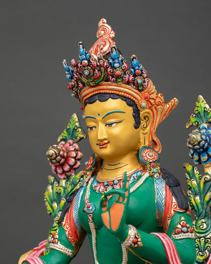 side close-up of green tara statue with colourful lotus seat detailing