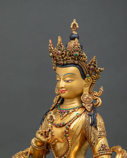 Side close up of handcrafted copper Vajrasattva statue with jewels.