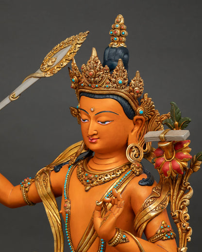 Side close-up of Manjushri Statue emphasizing lotus pedestal and gold-gilded copper craftsmanship