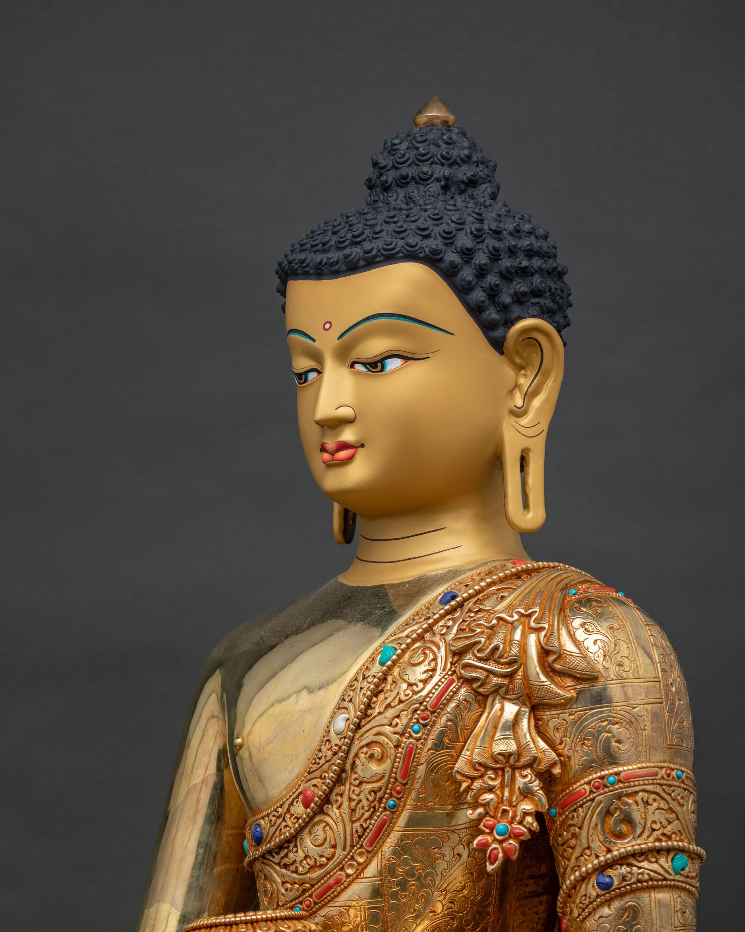 Side close up of Shakyamuni Buddha statue, hand-chased robe and halo detailing