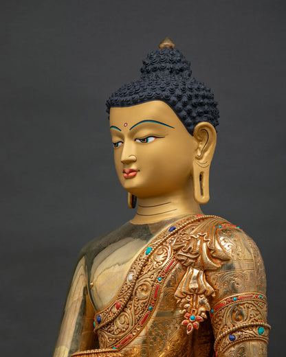 Side close up of Shakyamuni Buddha statue, hand-chased robe and halo detailing