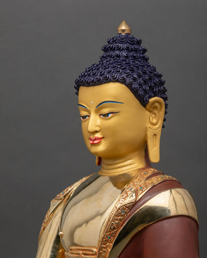 side close up of Shakyamuni Buddha statue with intricate gold gilded lotus throne