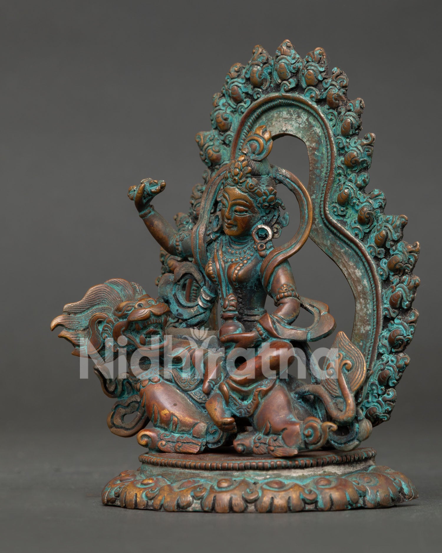 side close up of tseringma statue showing lotus throne and traditional details