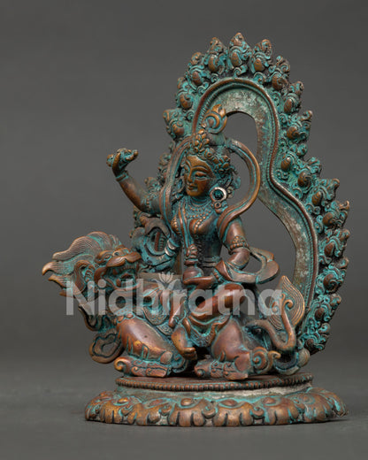 side close up of tseringma statue showing lotus throne and traditional details