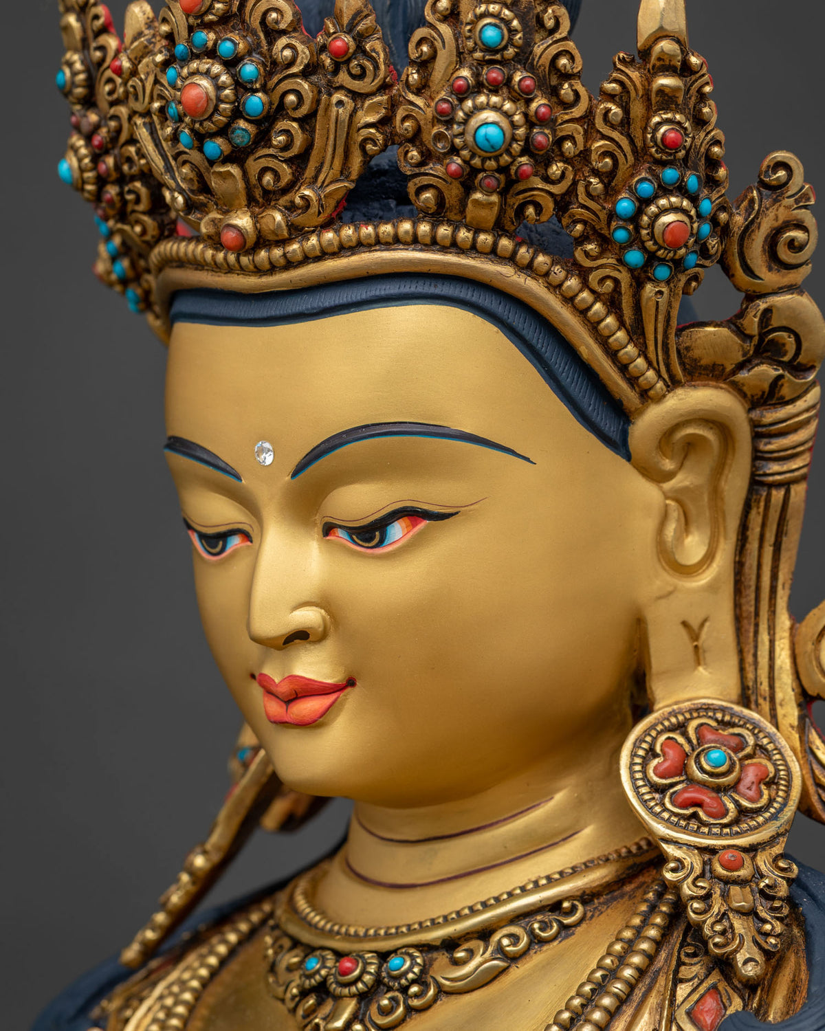 Side close-up of Vajrasattva face with polished 24K gold fire-gilded finish