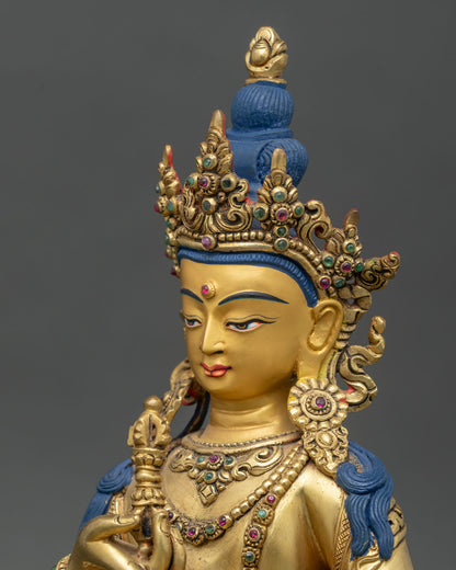 Side close-up of Vajrasattva statue highlighting ornaments, vajra, and lotus throne details
