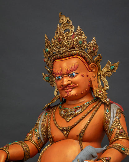 Side close up of Yellow Dzambhala statue showing mongoose, citron fruit and lotus seat carving