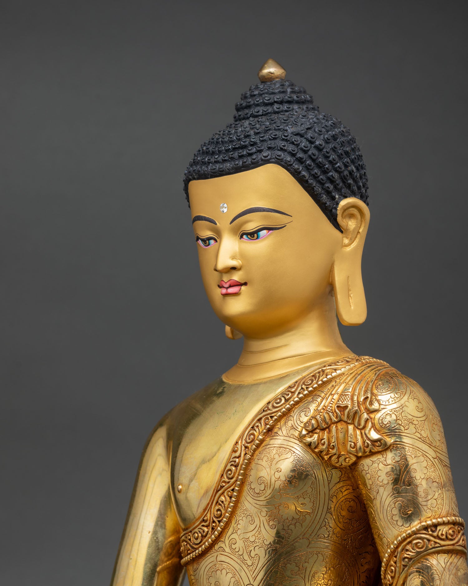side close up shakyamuni buddha gold fire gilded robe carving lotus base gemstone halo detail