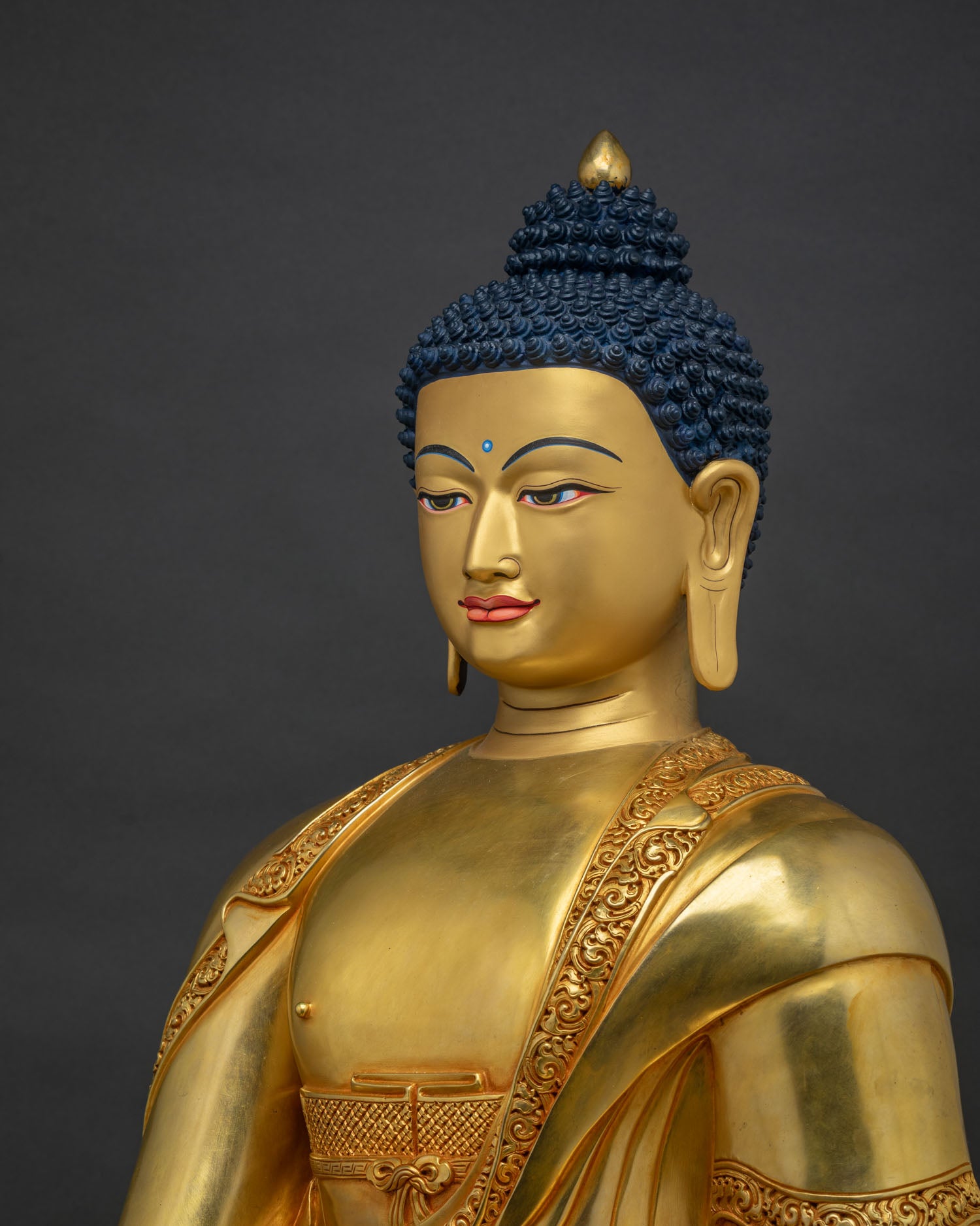 Side close-up view of gold gilded Buddha statue highlighting detailed craftsmanship and gold finish.