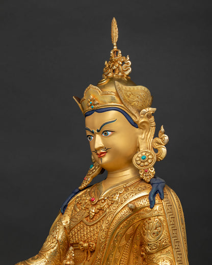 Side close up view of Nepalese copper alloy Padmasambhava statue with Khatvanga trident staff.