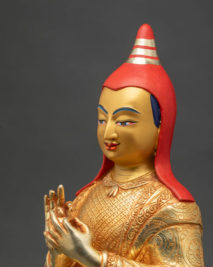 Side detail close up of Atisha statue showing engraved robes and lotus pedestal