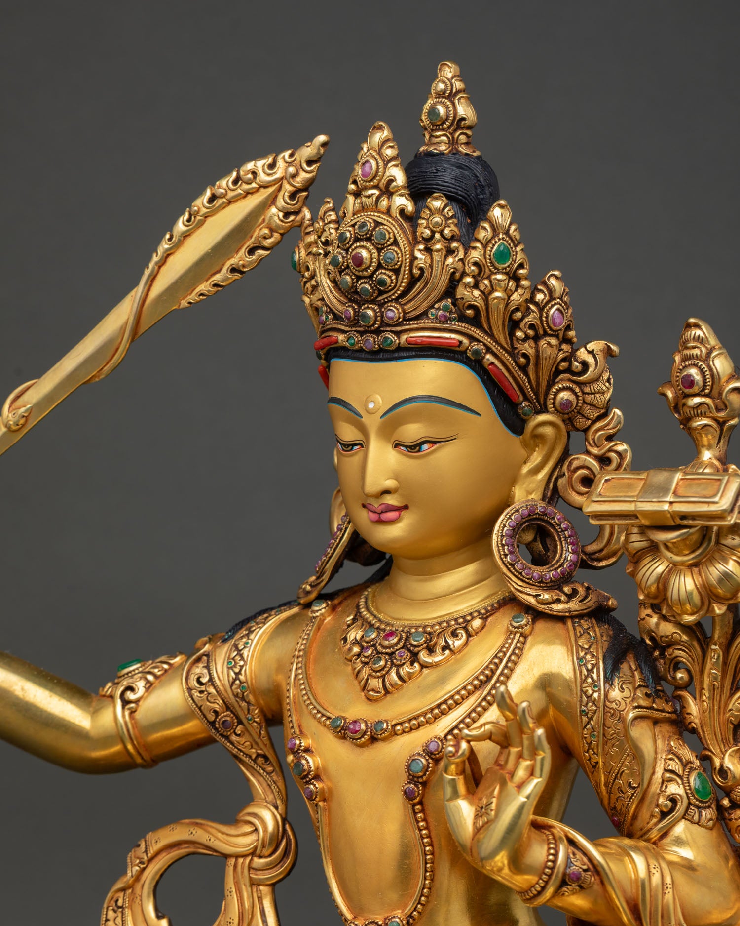 Detailed side close up: side detail Manjushri statue Nepal repoussé metalwork lotus seat ornaments carving
