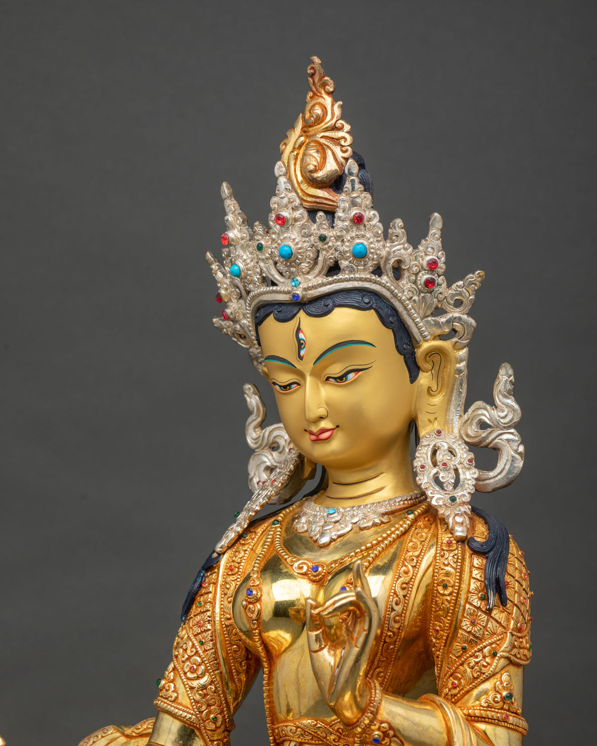 Side detail of Dukar Statue showing hand-chased gold-gilded robe and semi-precious stone inlay, Nepal