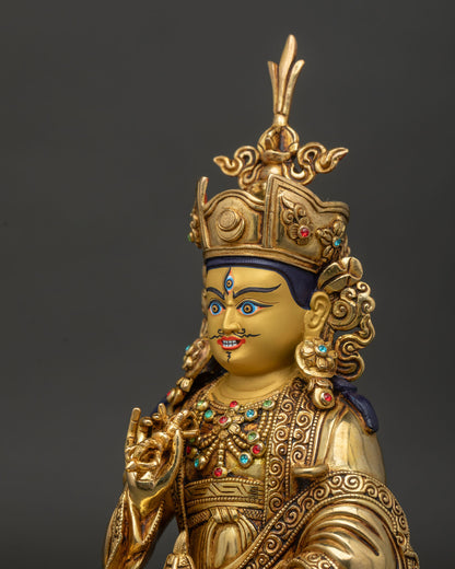 Side detail of Guru Tsokye Dorje Statue showing vajra, skull cup, and gold gilded craftsmanship