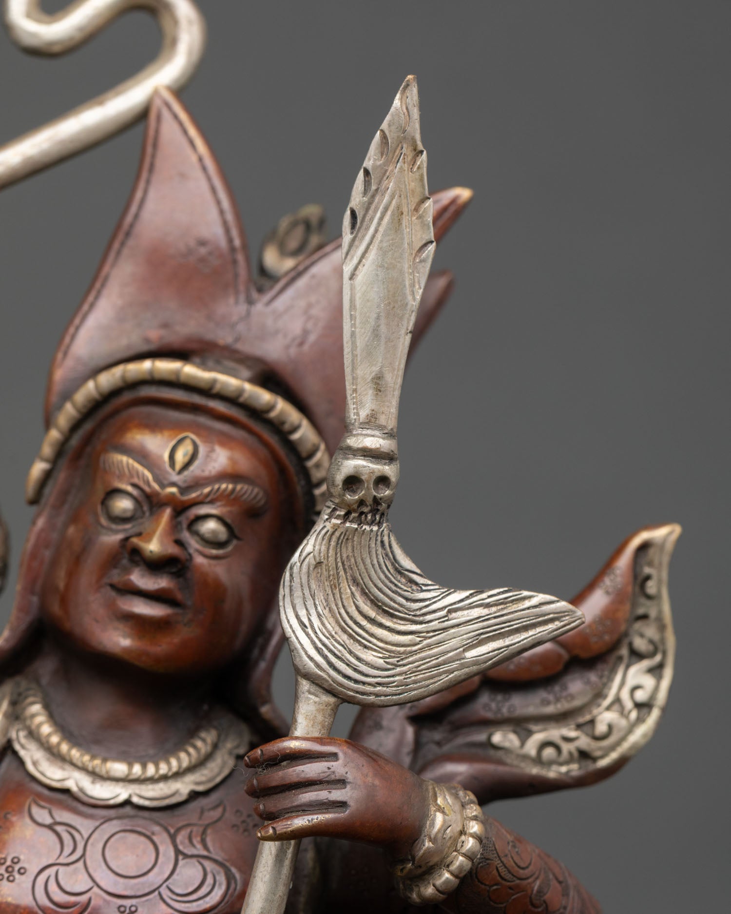 side detail of king gesar statue featuring horse ornaments and flaming halo design